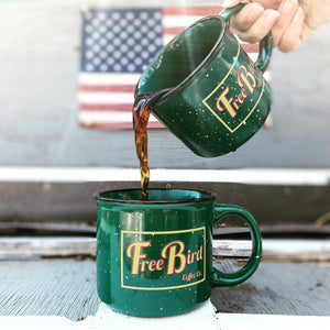 camping mug, ceramic mug, green with white speckles, 15 ounce mug, yellow and red free bird coffee co logo