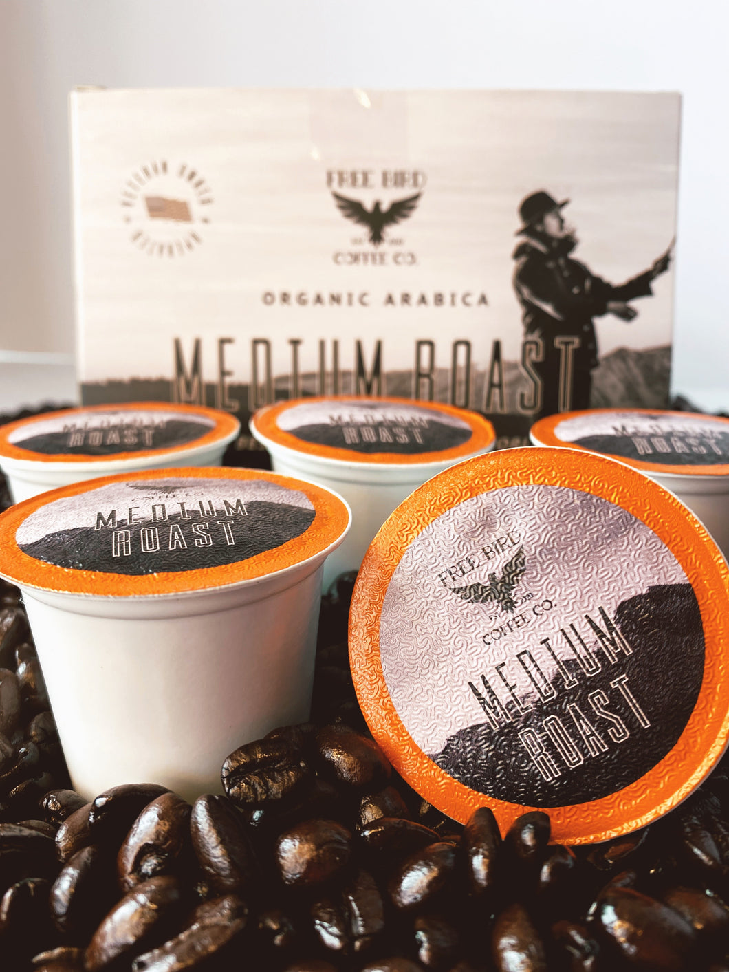 Free Bird Organic Coffee, best k cup coffee, Medium Roast K-Cups, Image of K cup coffee on a bed coffee beans.